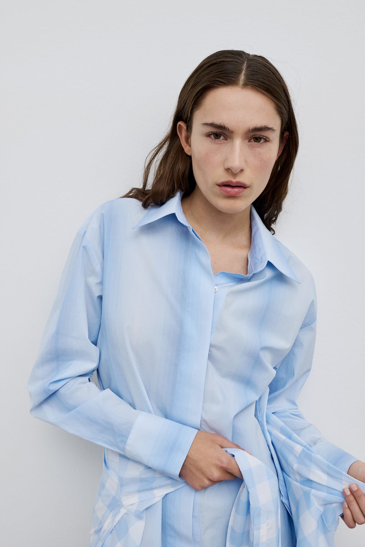 Model styling Vega classic cotton shirt, a refined blue striped cotton shirt for everyday elegance.