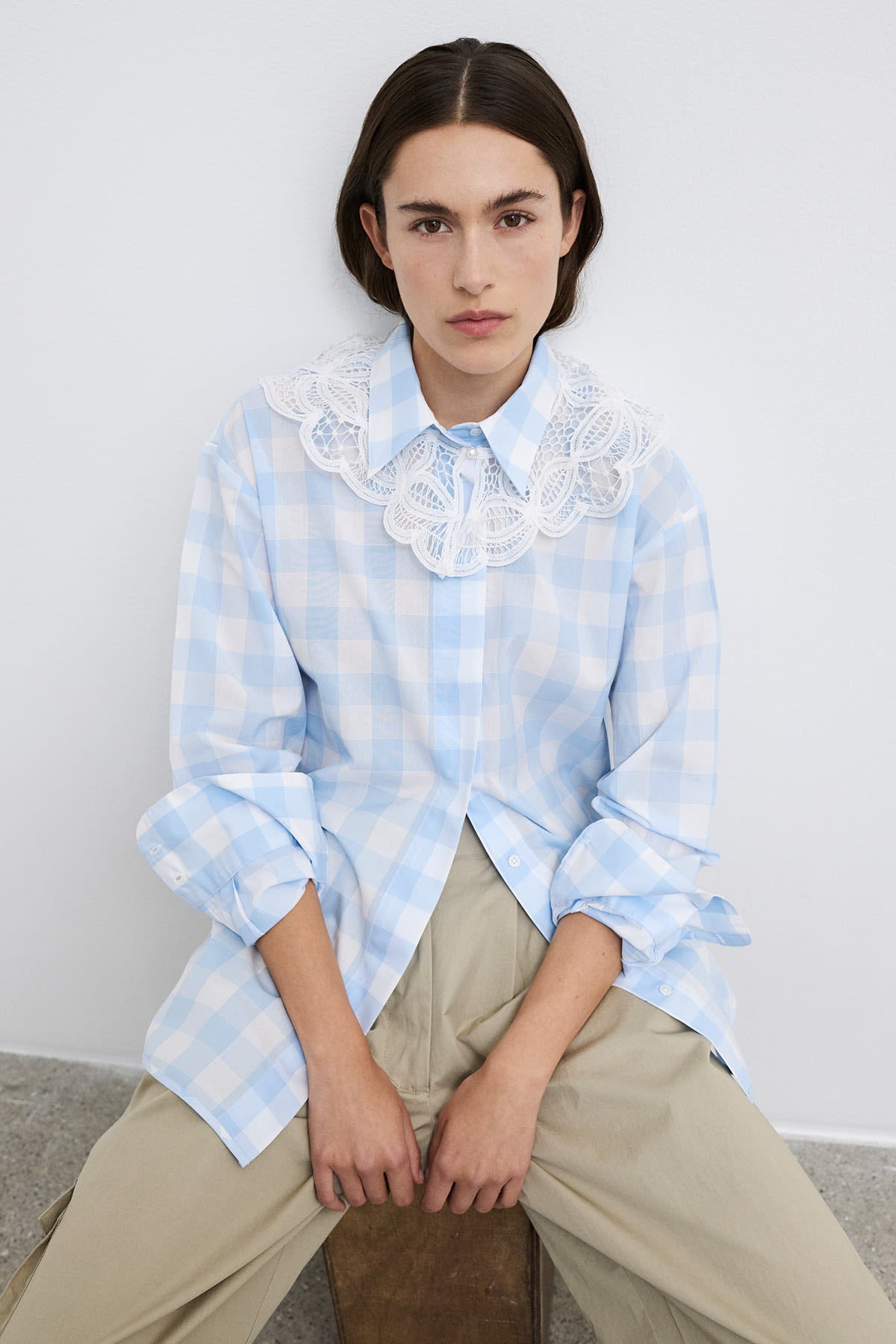 Model wearing Vega bold checked shirt, a blue checked cotton shirt, styled with relaxed elegance.