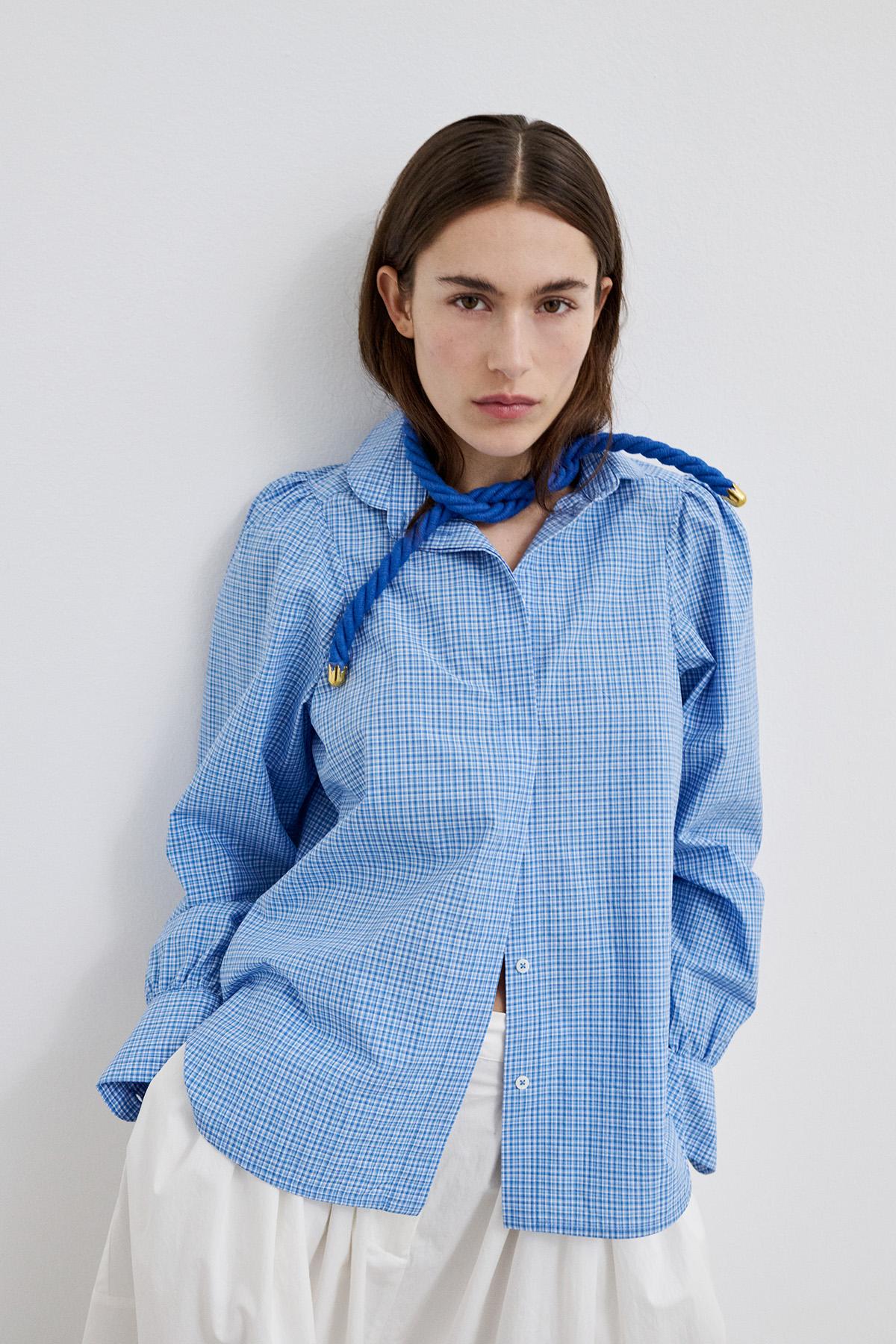 Close-up of the peter-pan collar shirt, highlighting its classic rounded design.