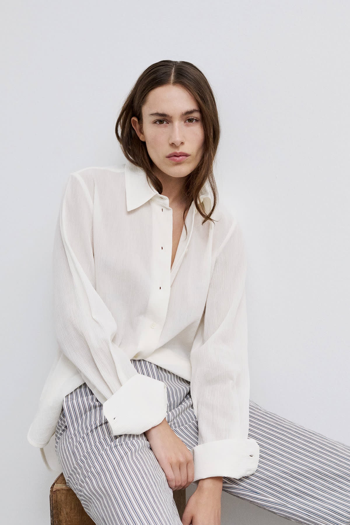 Model wearing Cecilie classic button-up shirt with a modern collar.