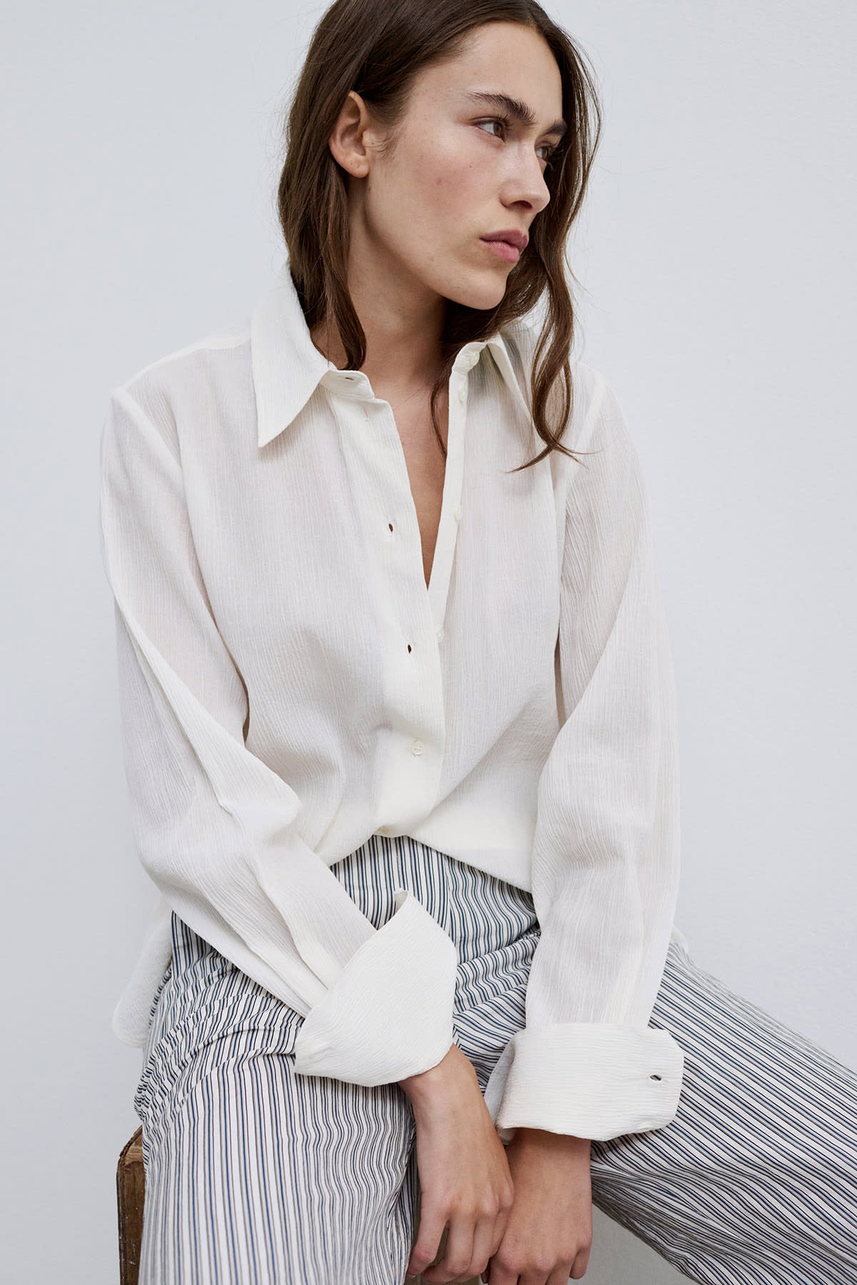 Model wearing Cecilie classic button-up shirt with a modern collar.