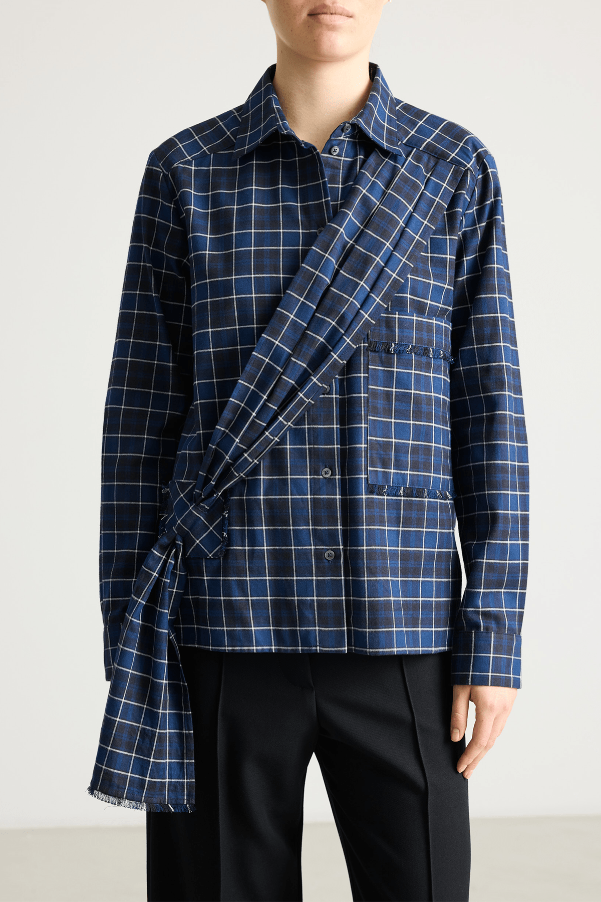 Model wearing Bene dark blue check cotton shirt with asymmetrical sash.