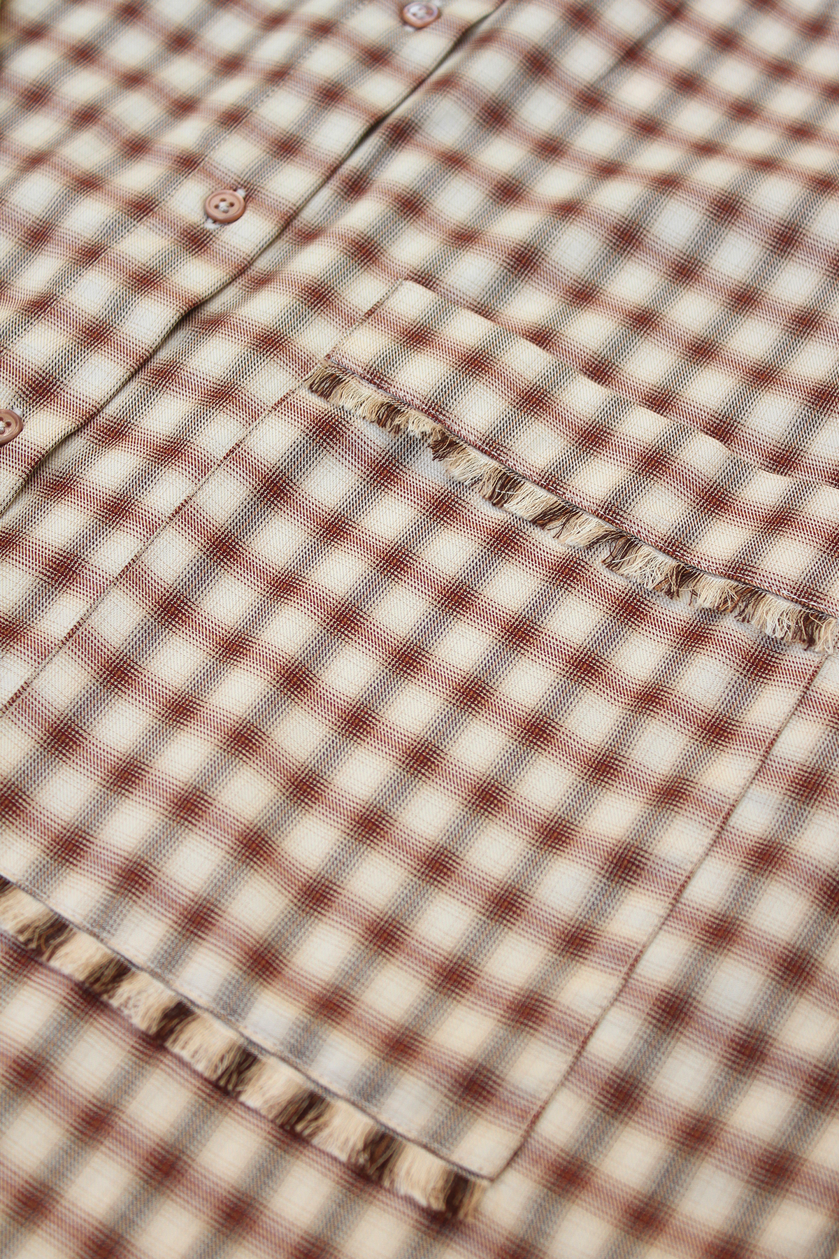 Close-up of Bene cotton shirt with asymmetrical sash.