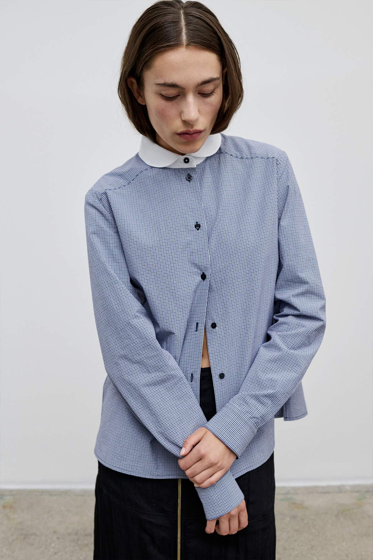 Model with the Bonnie Shirt – Blue checkered shirt with Peter Pan collar in white and black button-up front.