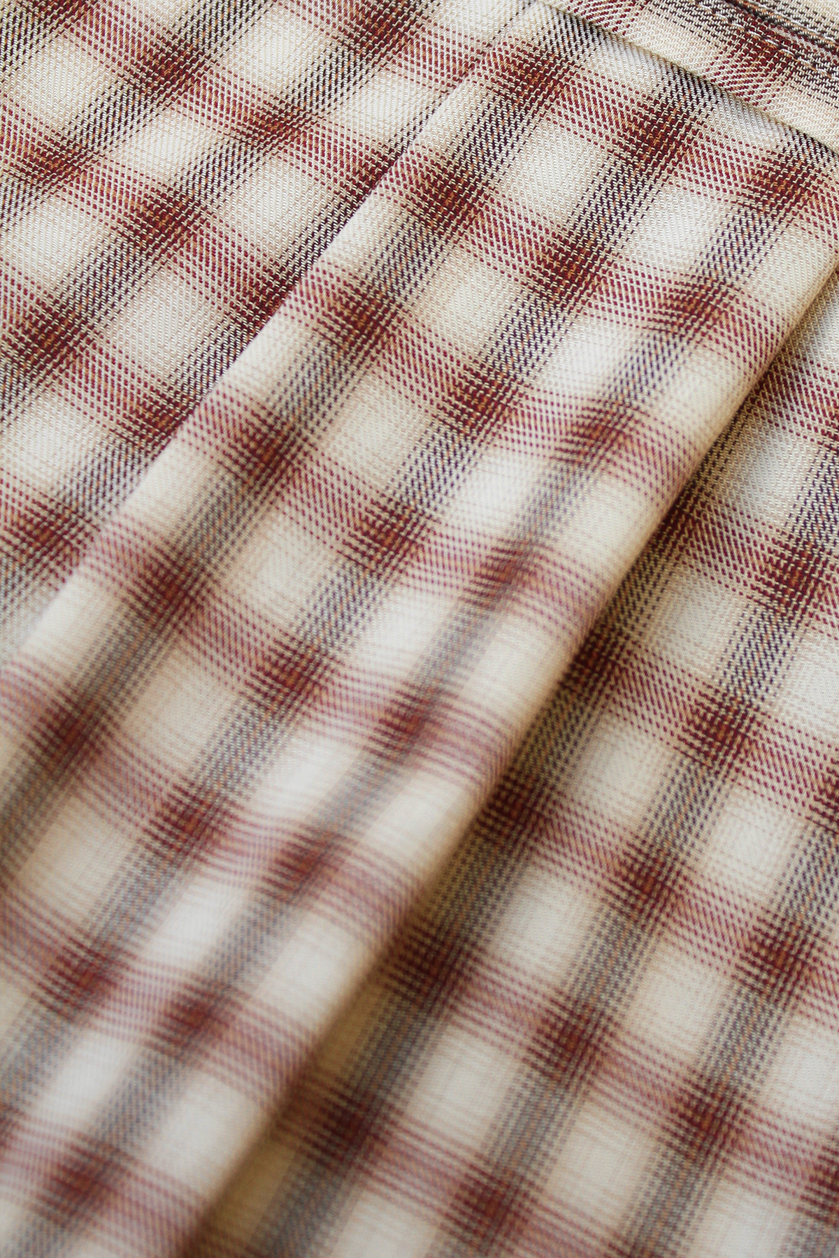 Close-up of Kendel cotton straight-leg trousers in warm graham check.