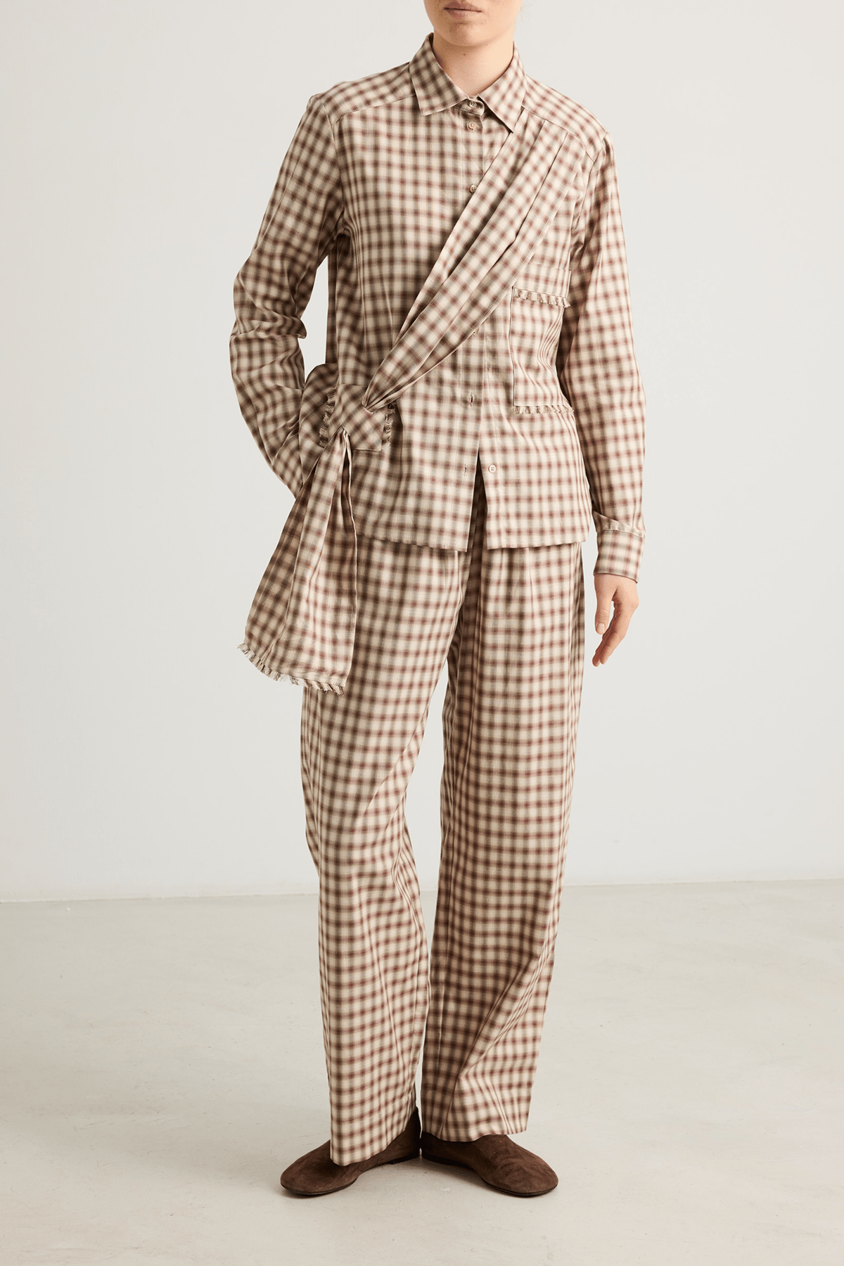 Model wearing Kendel cotton straight-leg trousers in warm graham check.