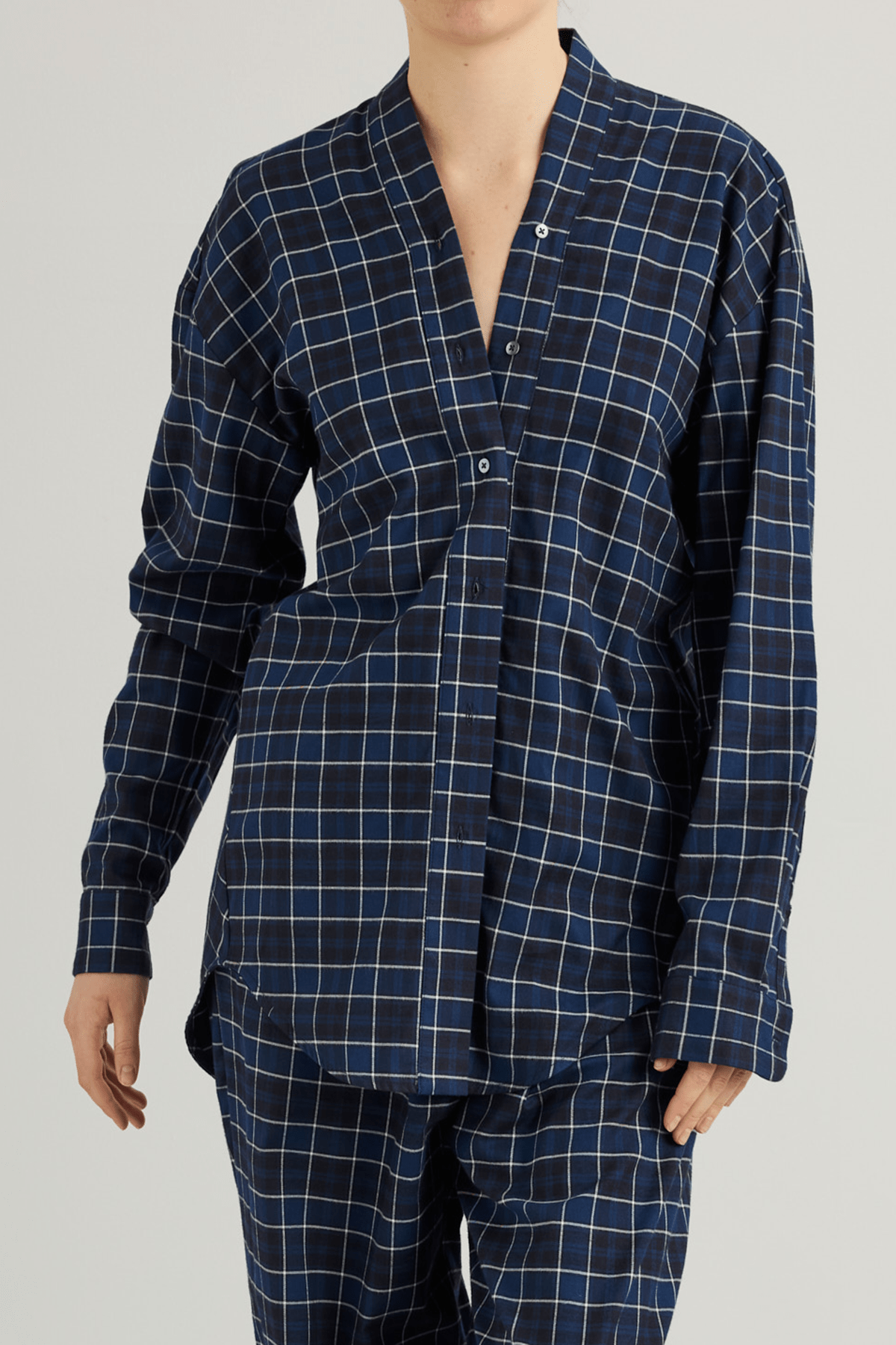 Model wearing the Mina shirt with V-neckline and draped back detail.