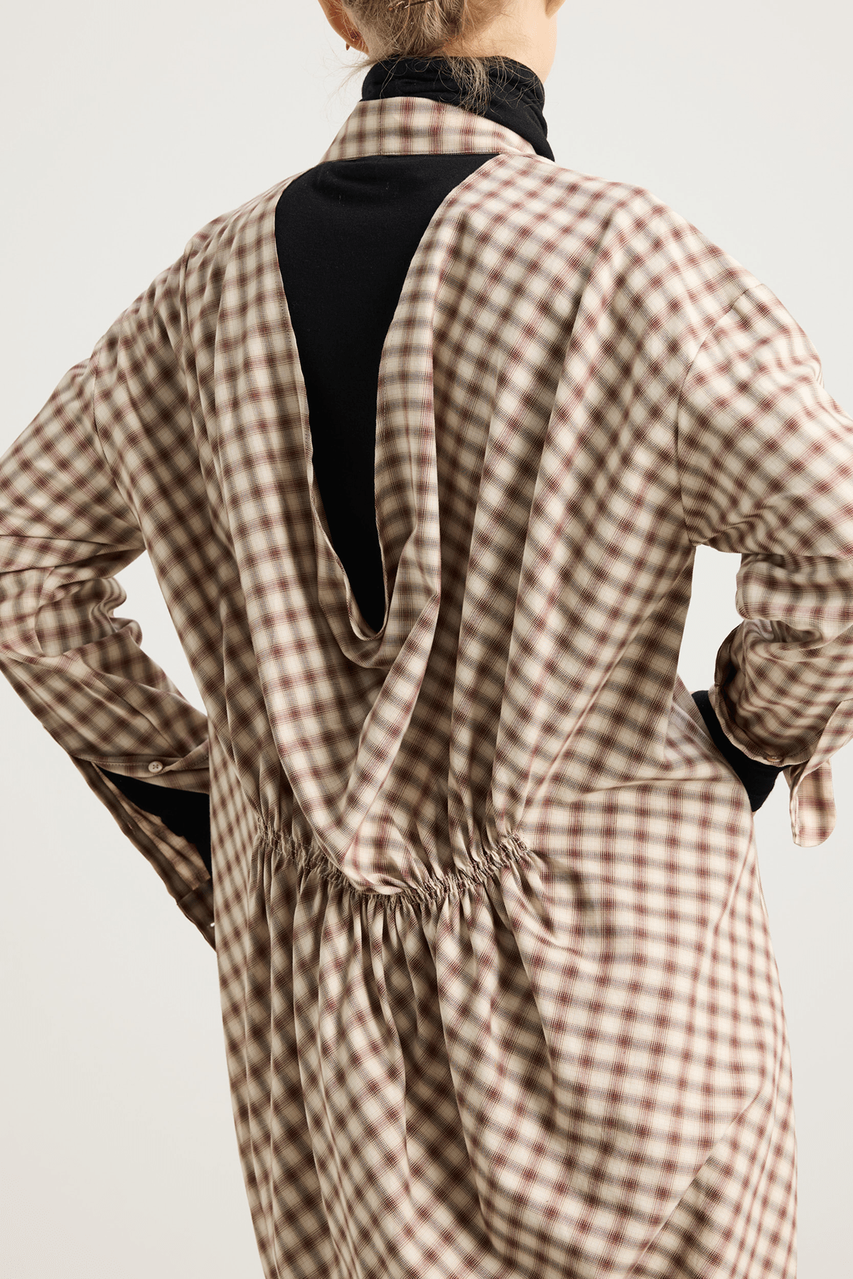 The Minal shirt dress with V-neckline and draped back.