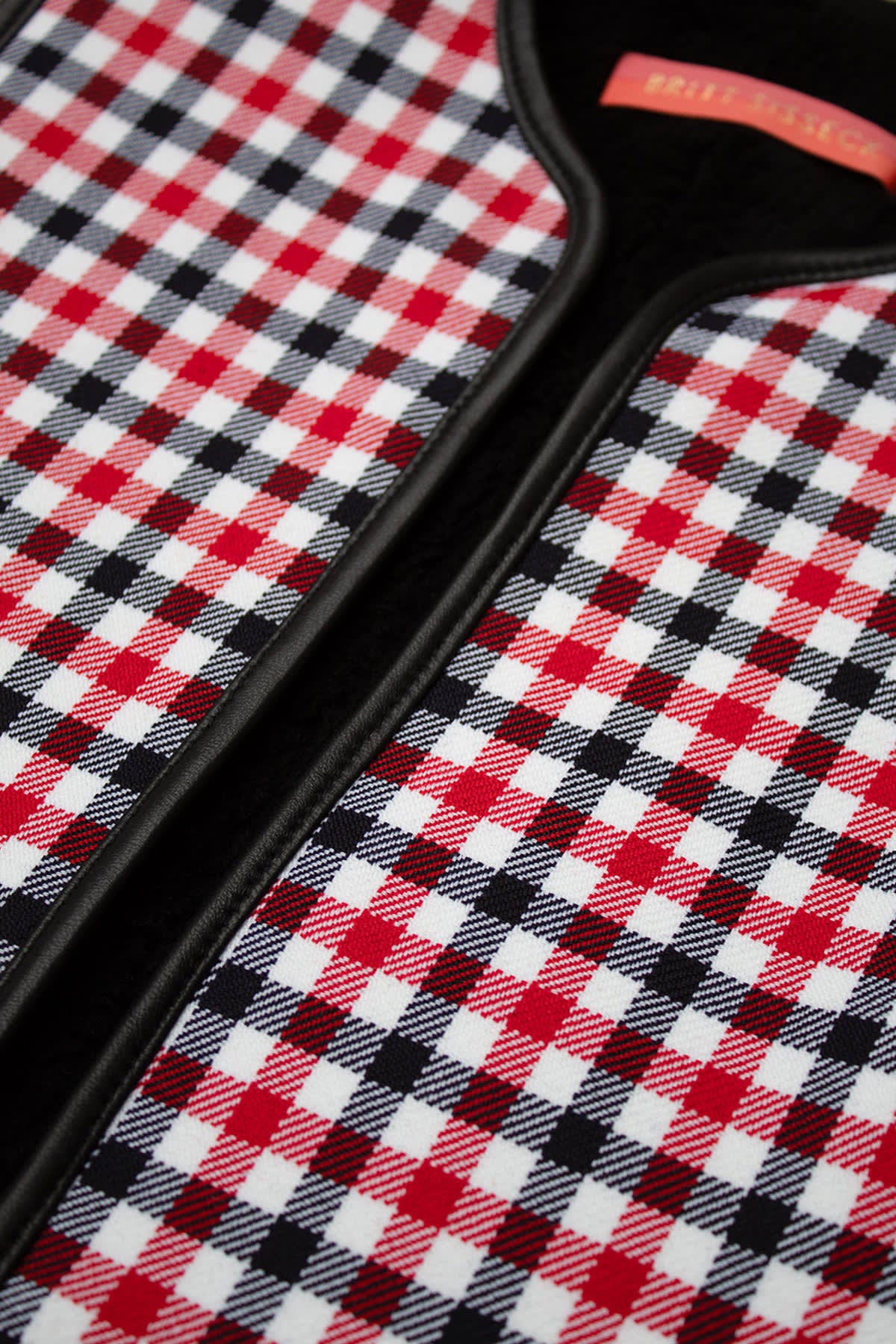 Tabitha wool vest in red and black check pattern with shearling lining and deep pockets.