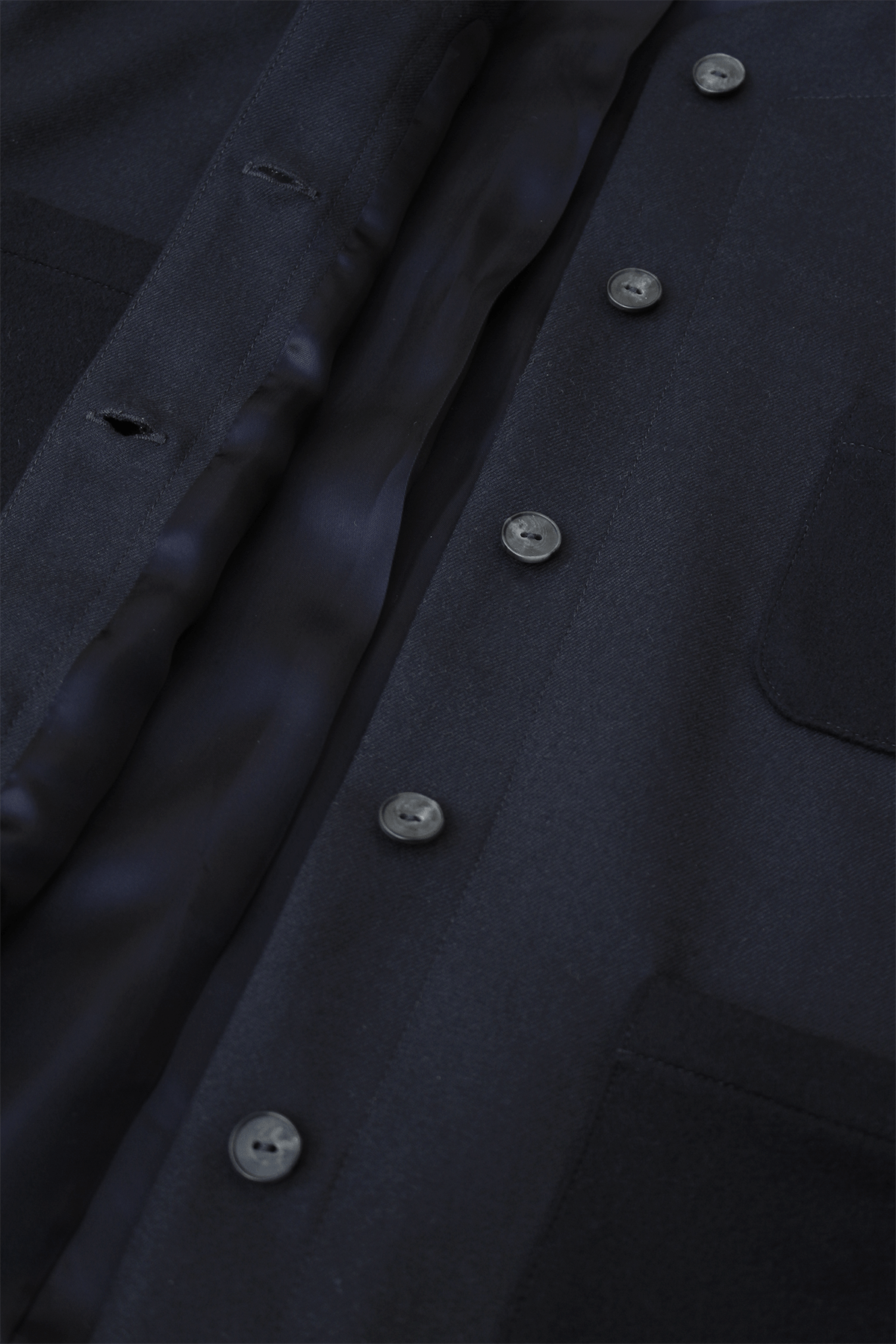 Close-up of dark blue Tinnie vest in cashmere–virgin wool.