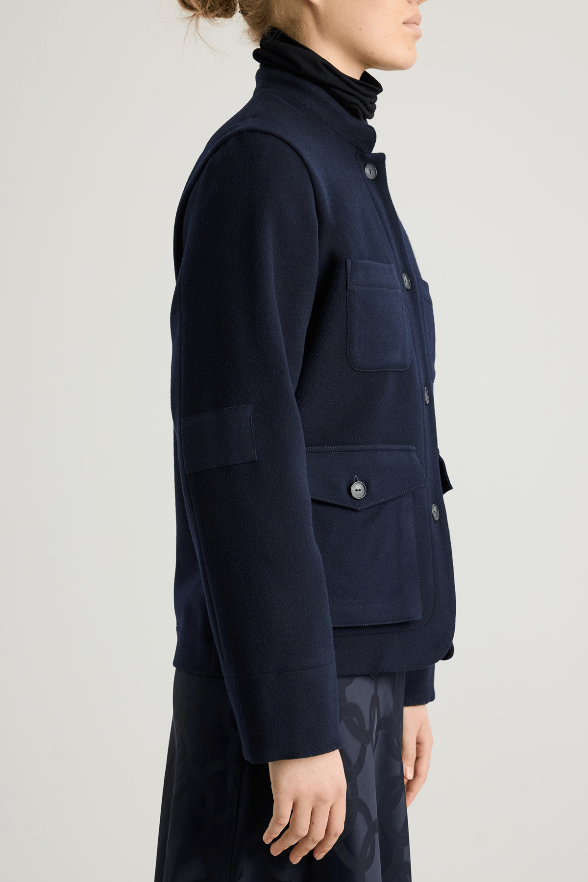 Model wearing the Torni wool jacket in Nightsky with stand collar and contrast patch pockets