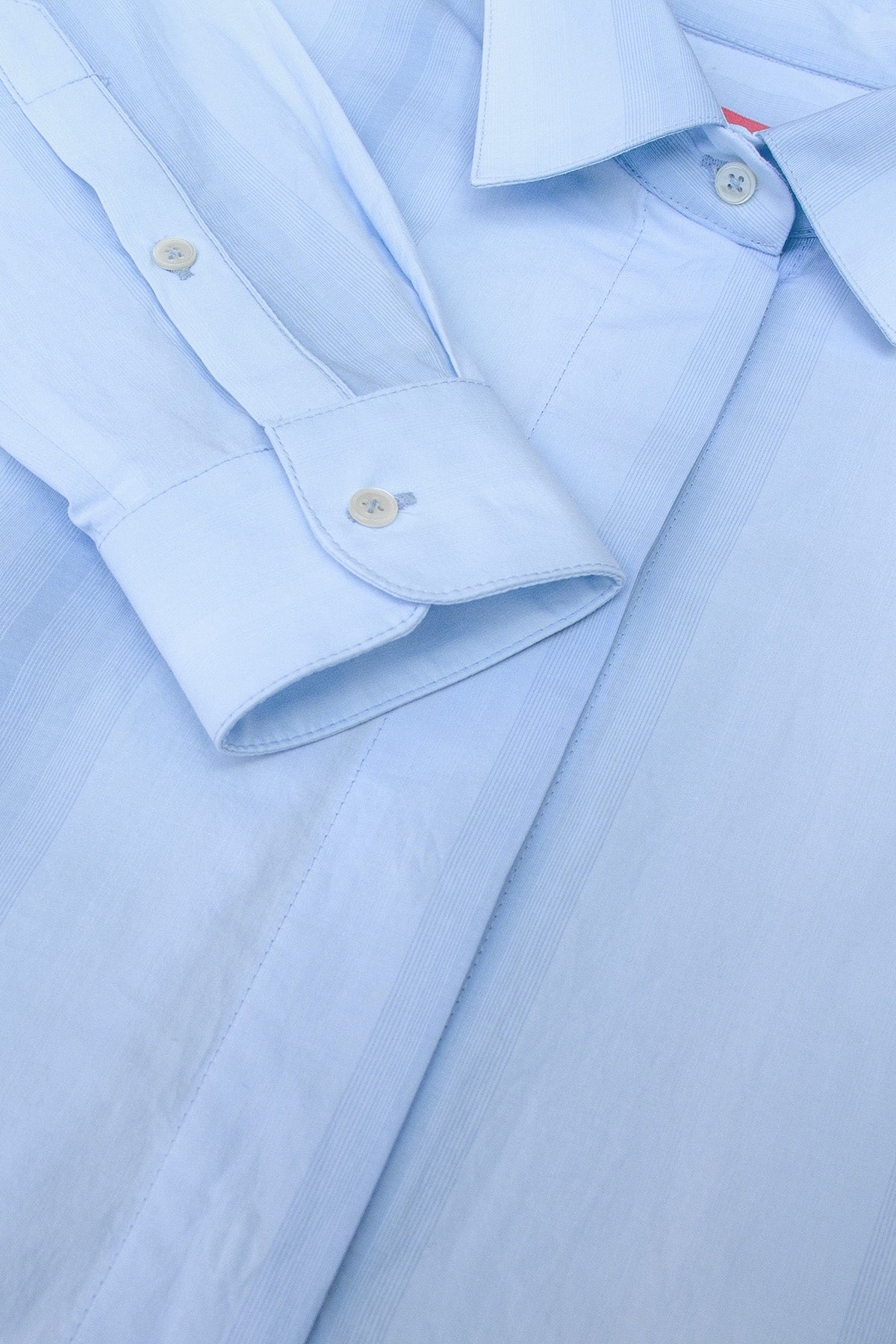 Close-up of Vega Gradient Striped button-up shirt, showcasing its tailored details and signature cuff design.
