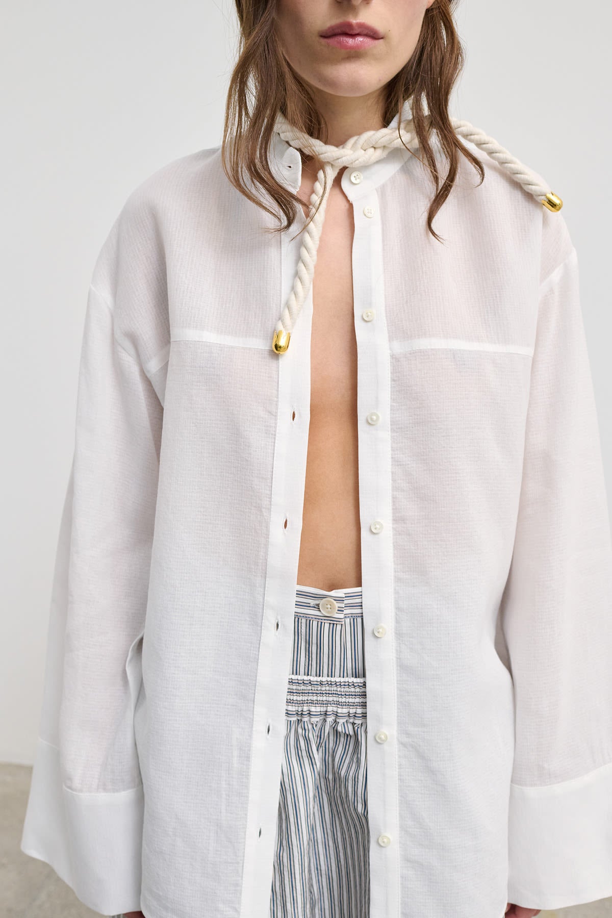 Model wearing Viola Structured cotton shirt with a blouse with wide sleeves, showcasing its sculptural design.