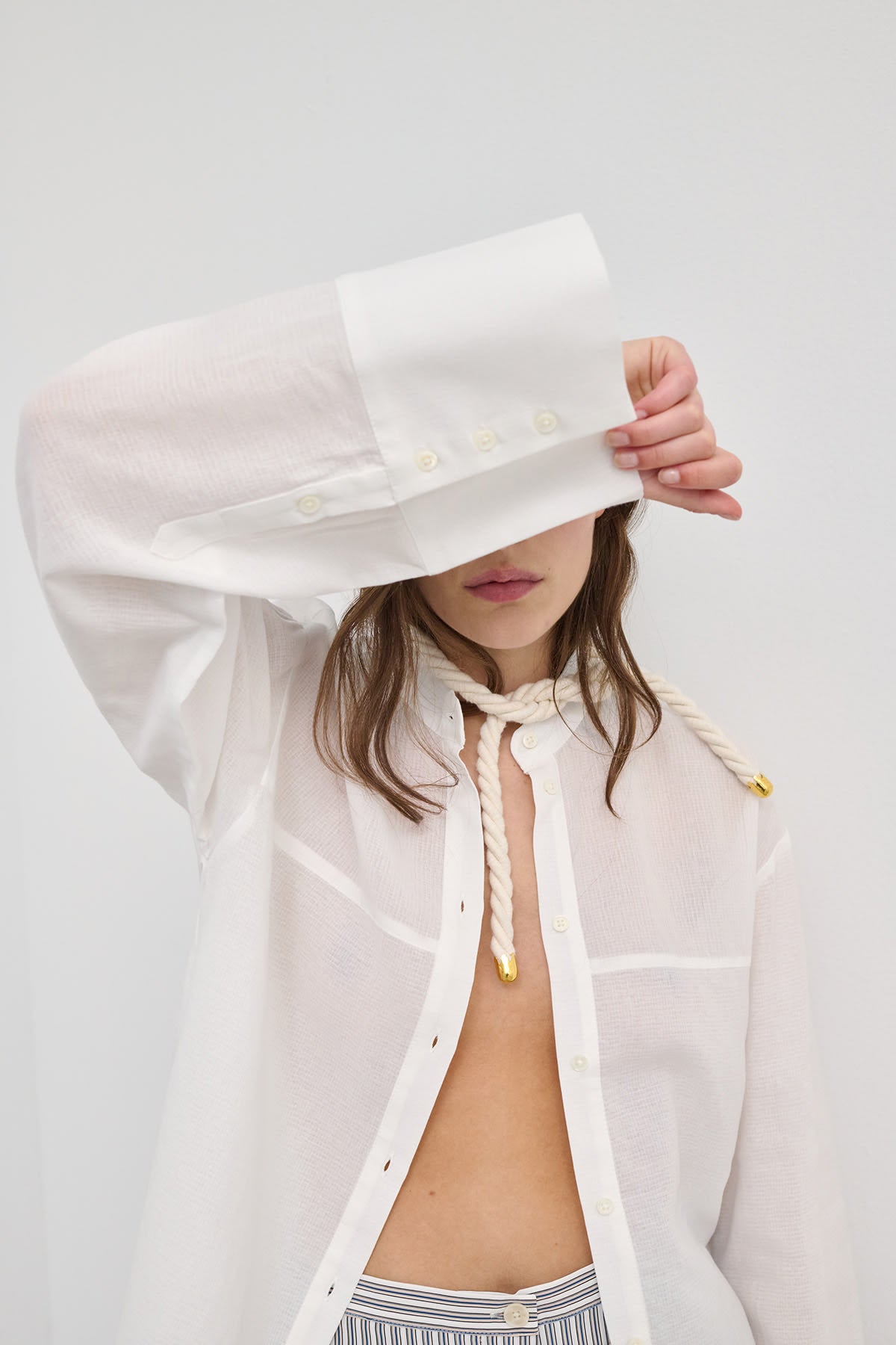 Model wearing Viola Structured cotton shirt with a blouse with wide sleeves, showcasing its sculptural design.