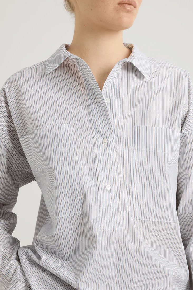 girl in white striped shirt with big pockets