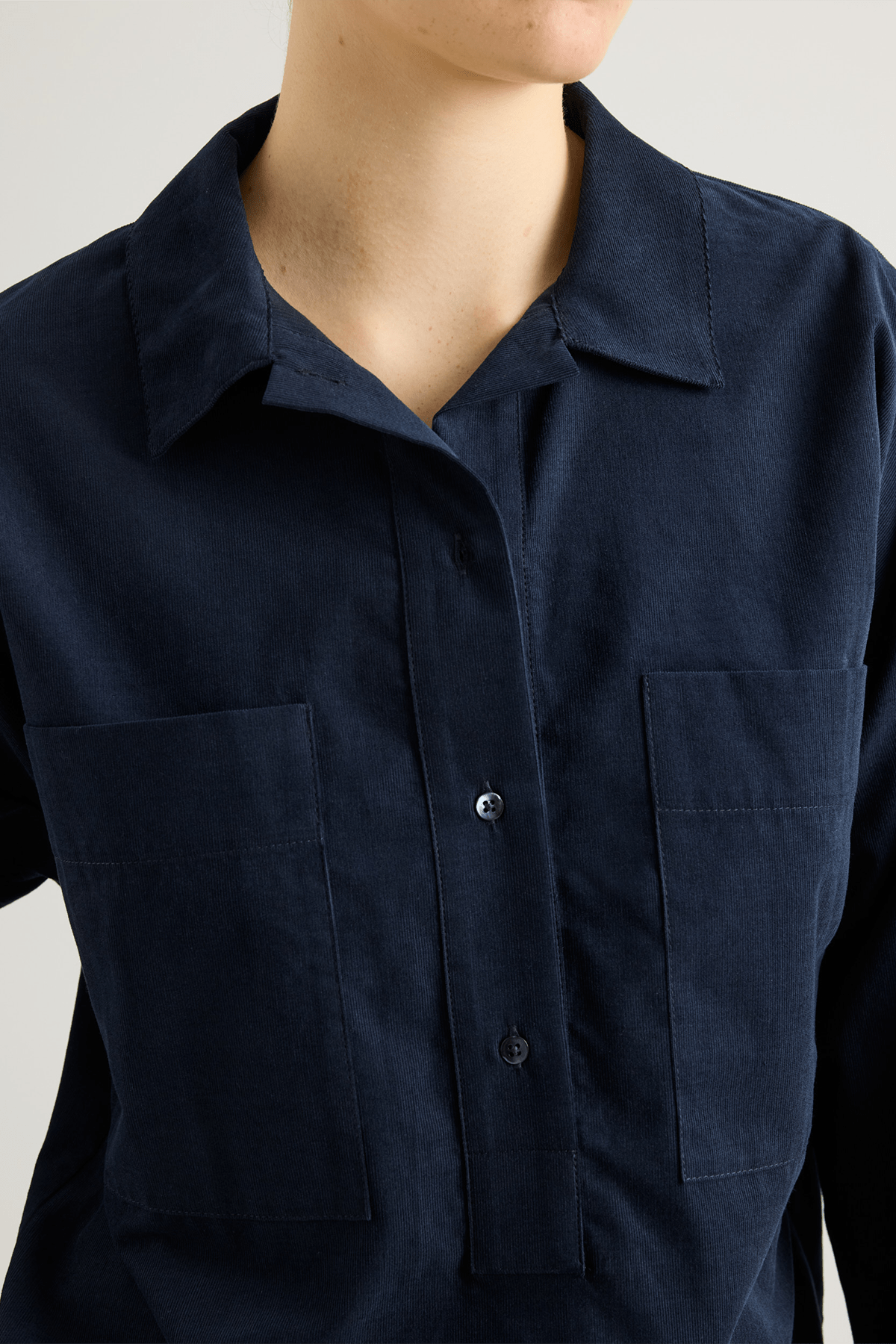 girl in Navy shirt with big pockets