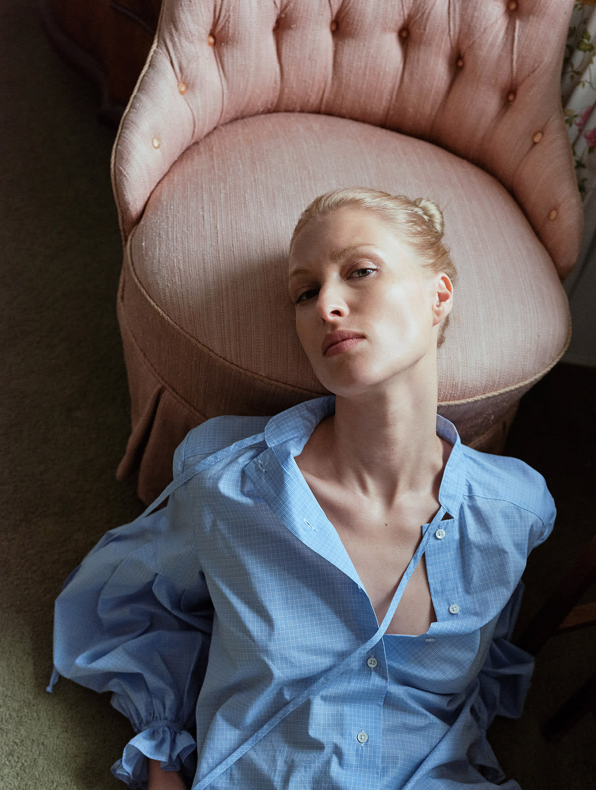 blonde girl laying on the floor wearing Light blue check blouse with a tie-neck detail, front button closure, and long voluminous balloon sleeves gathered at the wrists