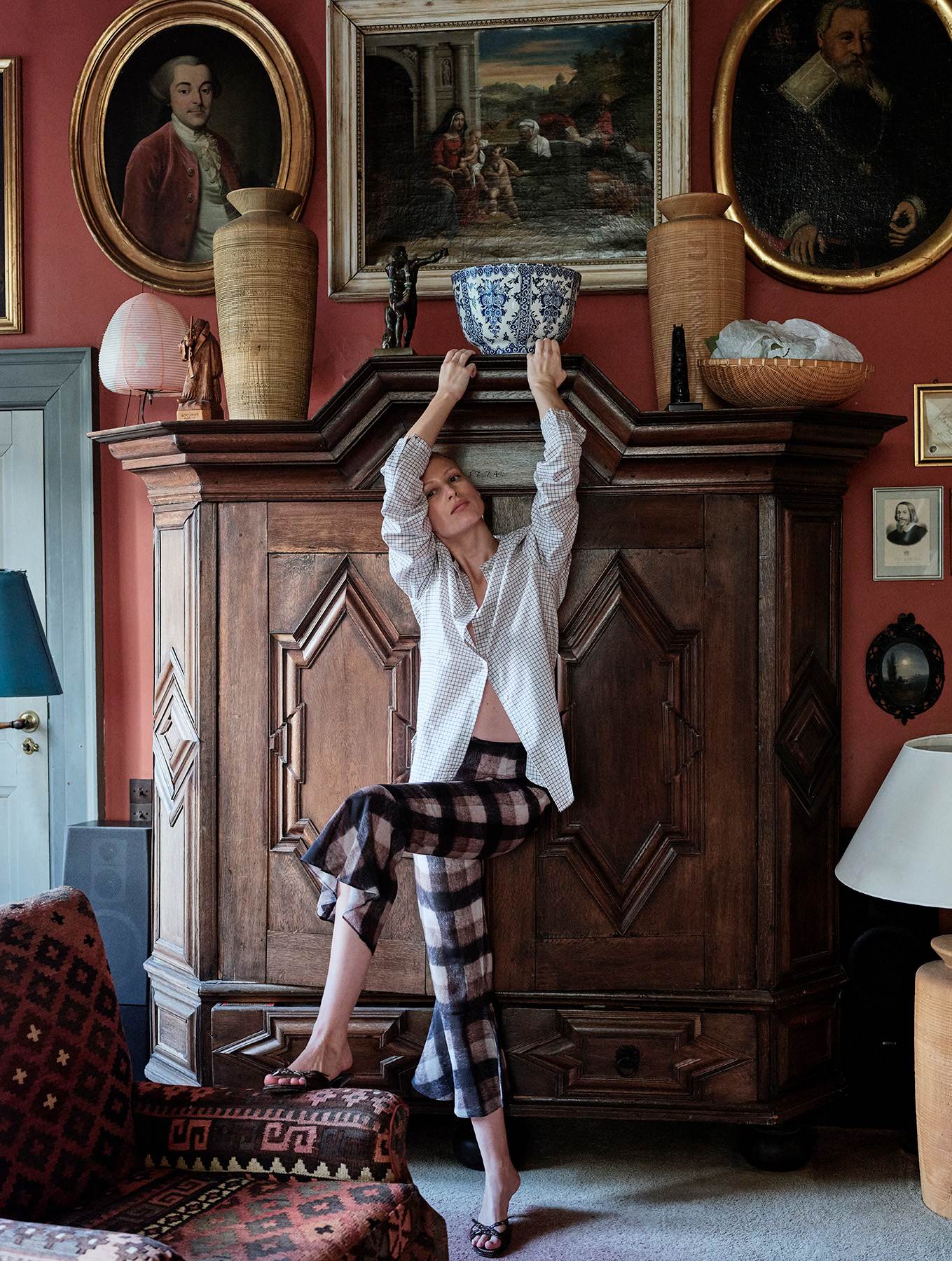 blonde girl in a lounge wearing white check shirt and brown check trousers
