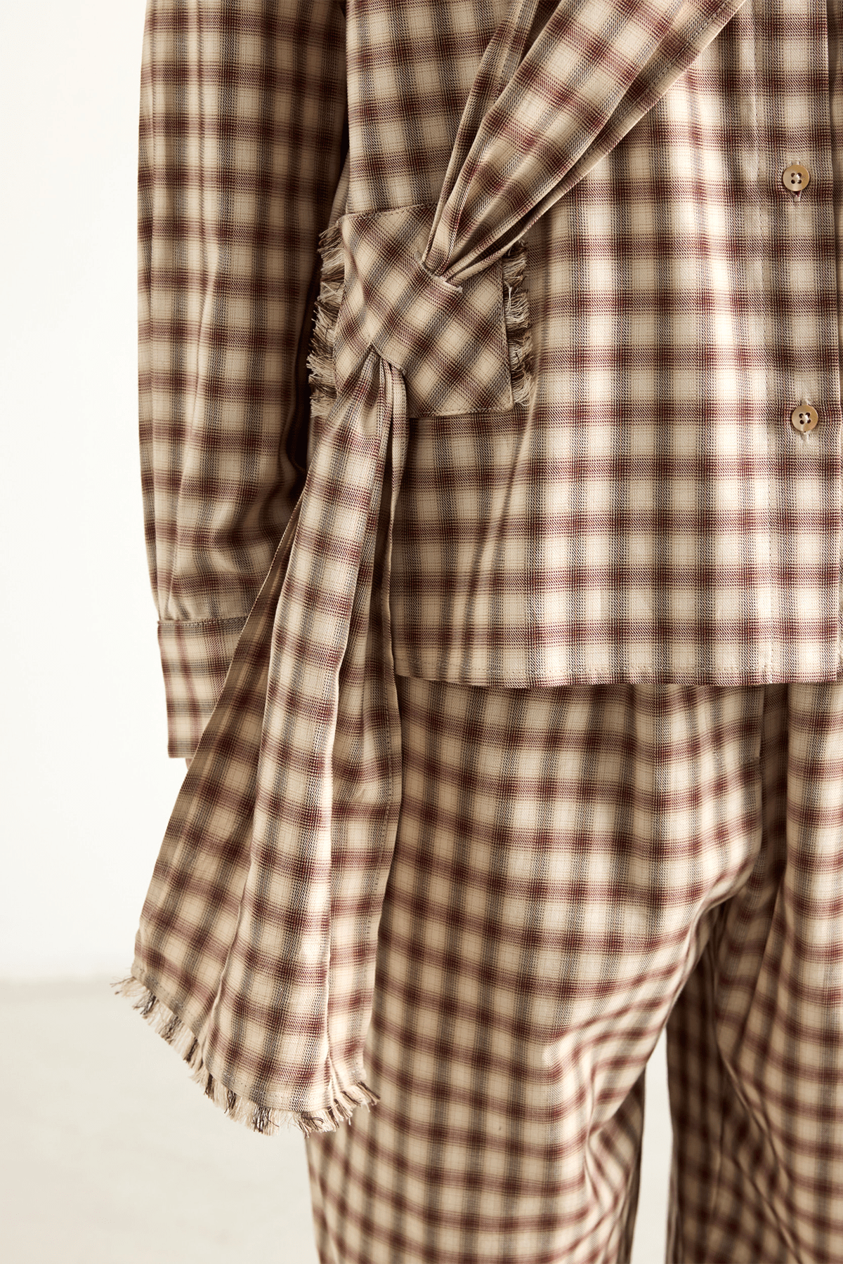 Checked brown shirt with a draped front tie detail