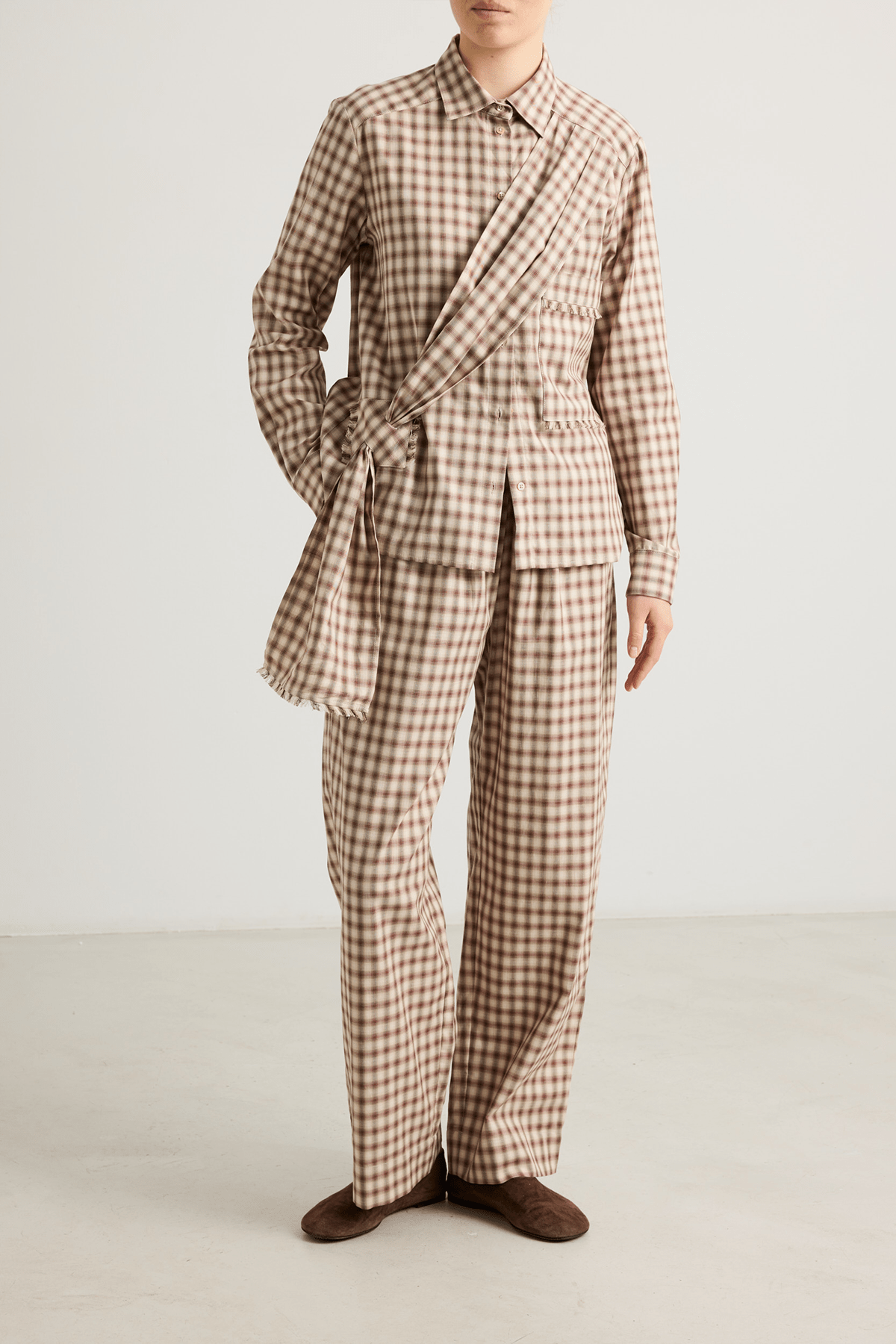 girl in Checked brown shirt with a draped front tie detail and check trousers