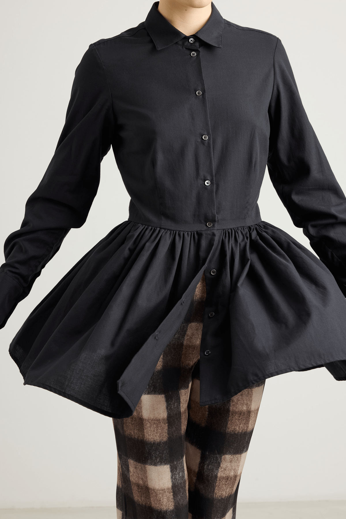 girl in Black long-sleeved mini dress with, button-down front, and gathered peplum-style skirt