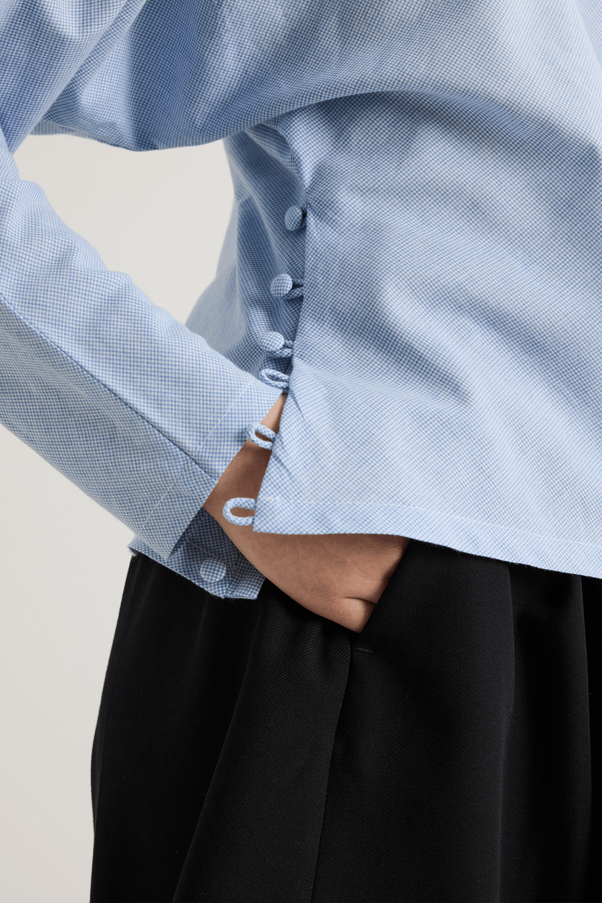 close up blue houndstooth top with buttoned detail