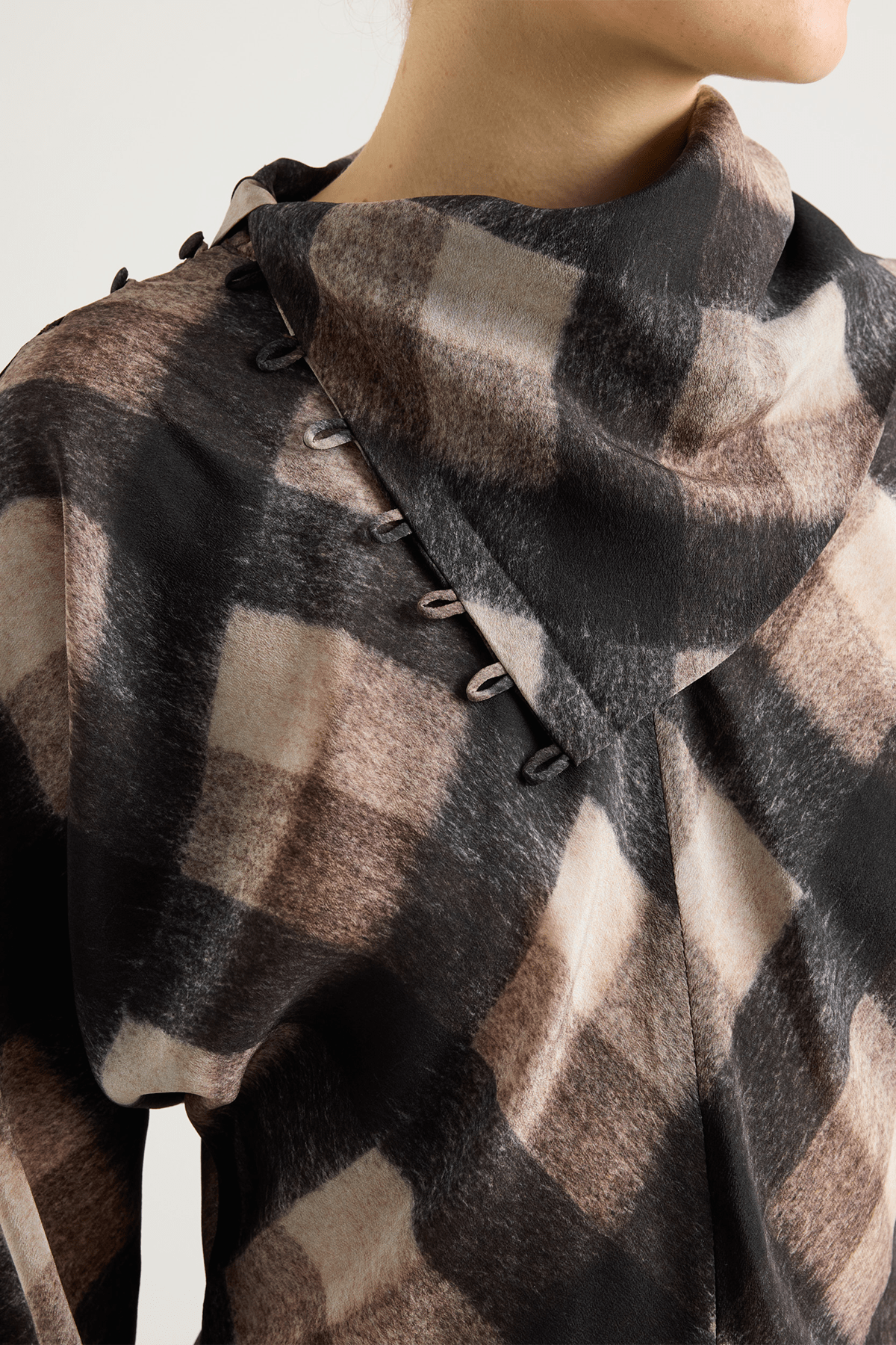 Brown and black check top with asymmetrical buttoned neckline