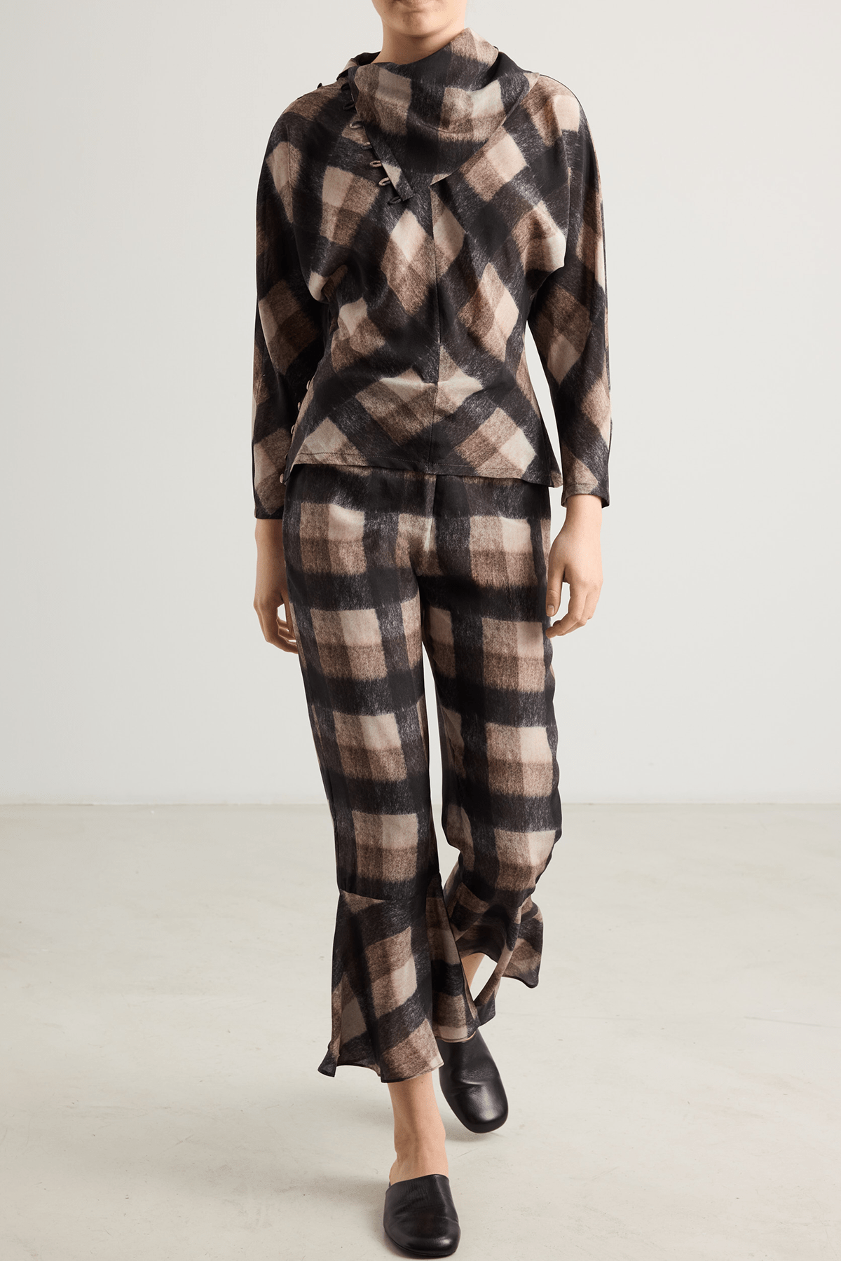 girl I Checked flared pants with ruffled hems and blouse in brown and black tones.