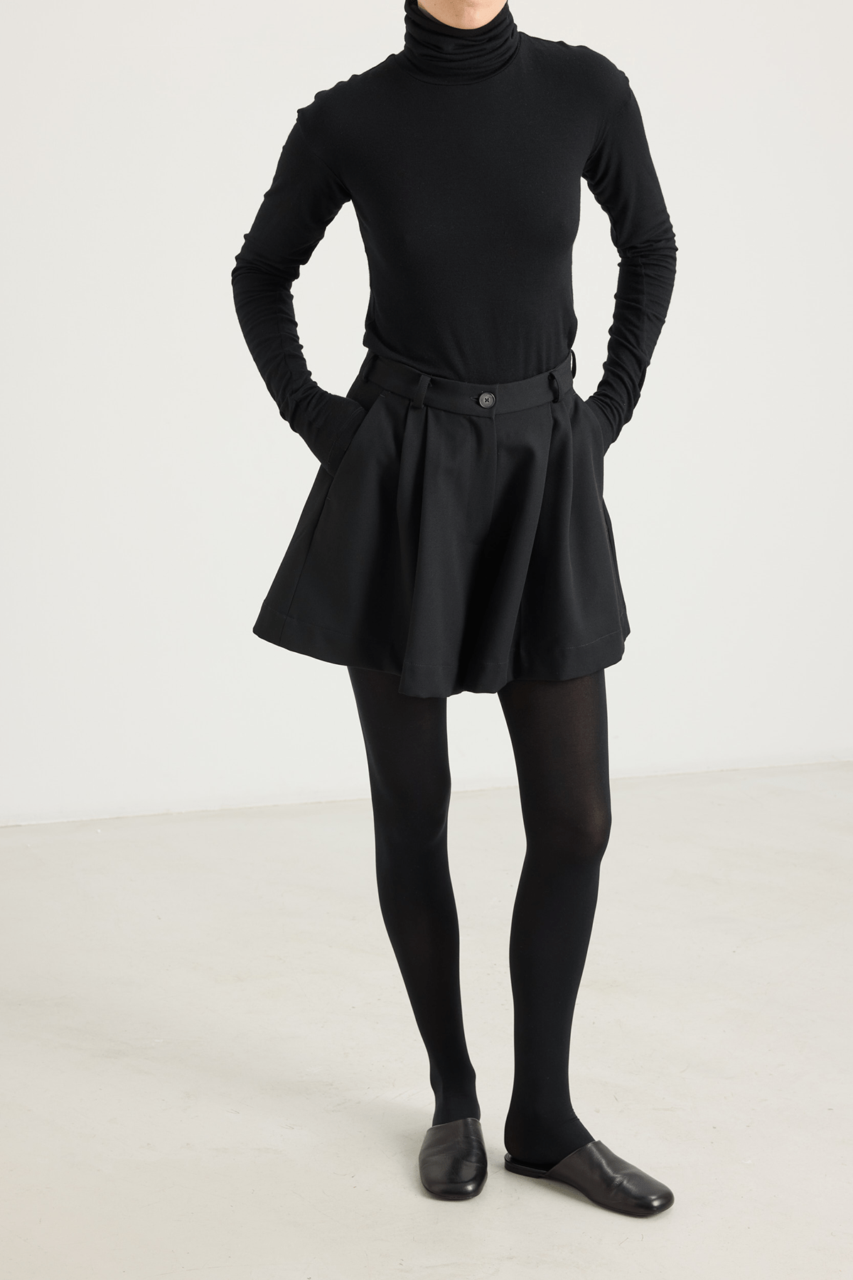 girl in black shorts and black turtleneck
