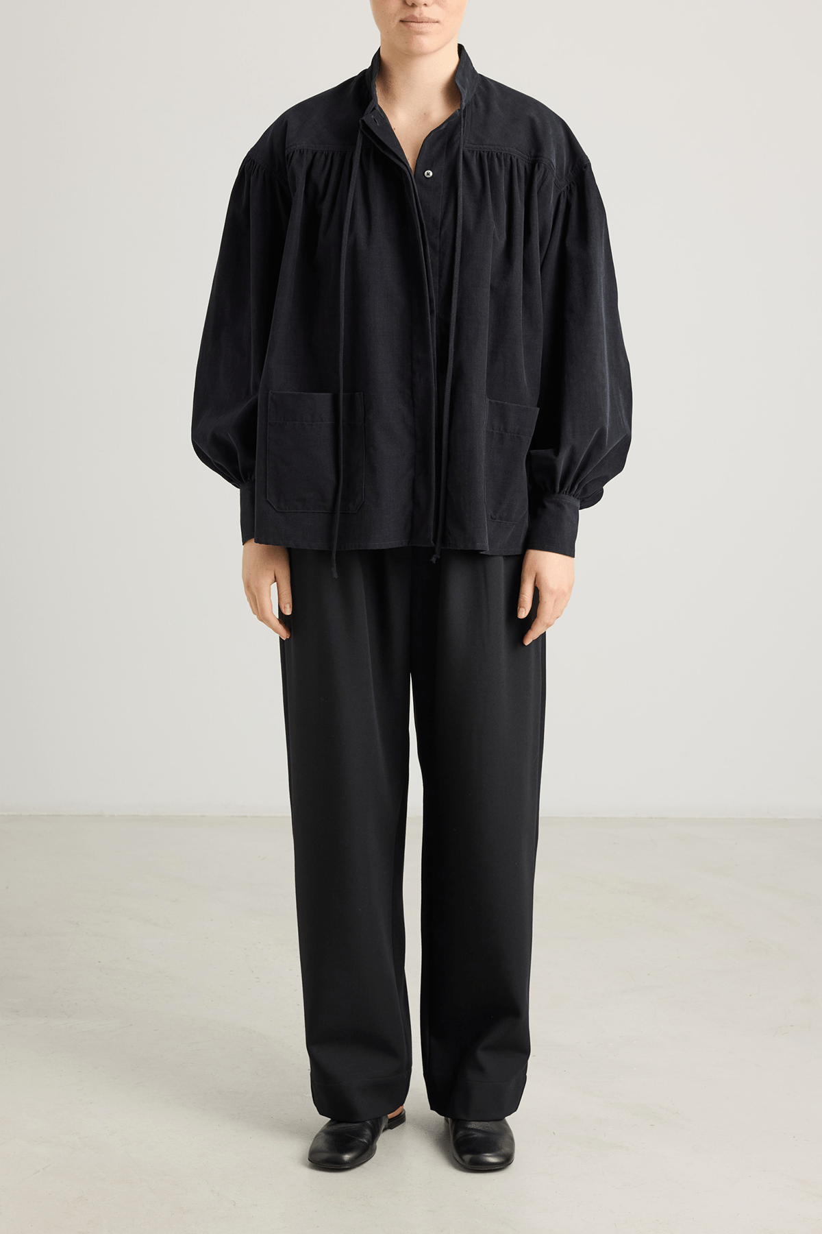 girl in black trousers and black shirt