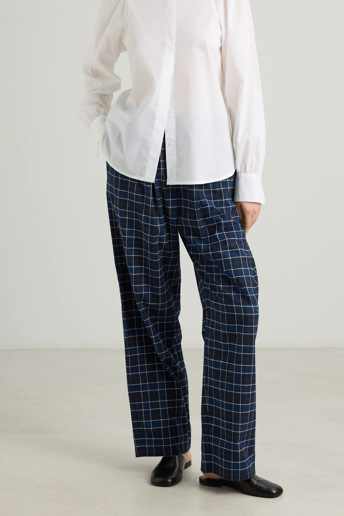 girl blue check trousers and white shirt