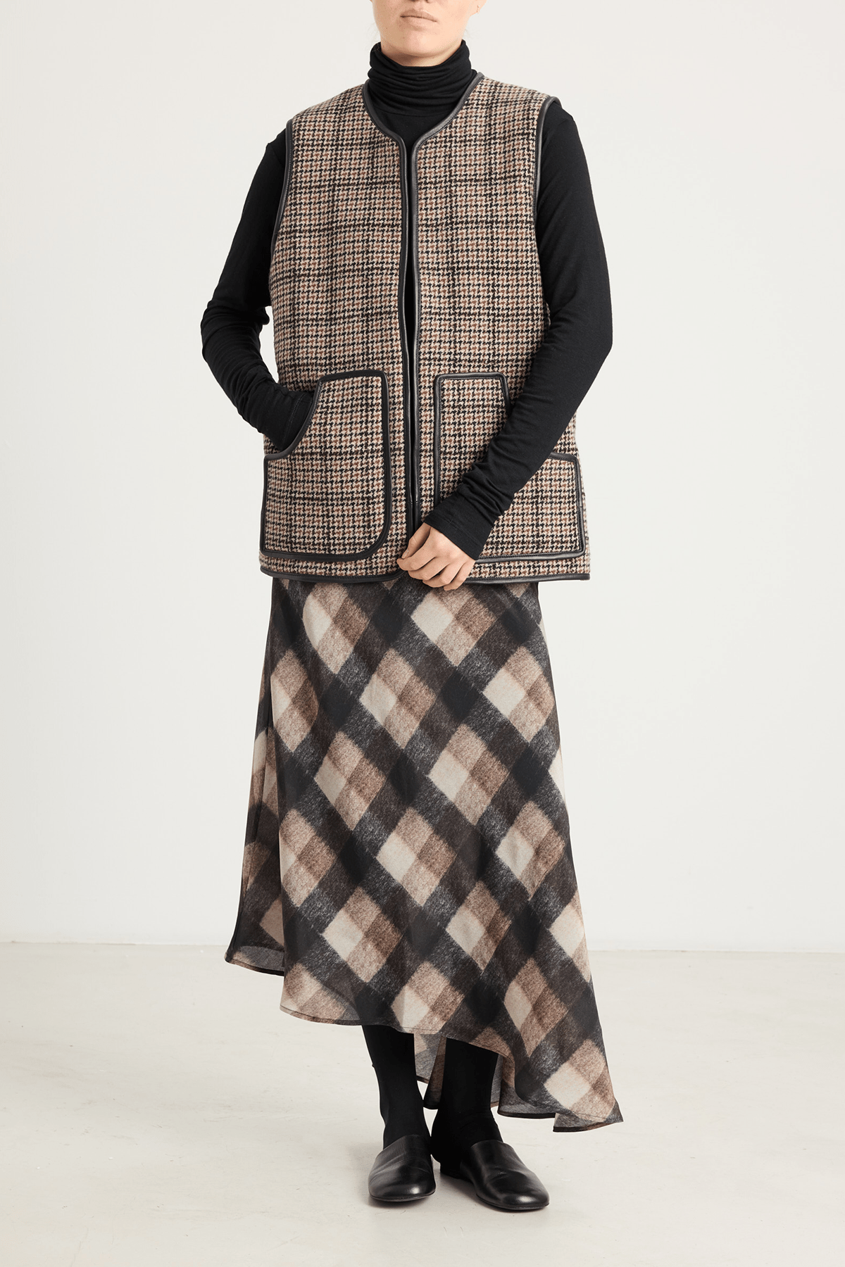 girl in houndstooth vest and brown check skirt
