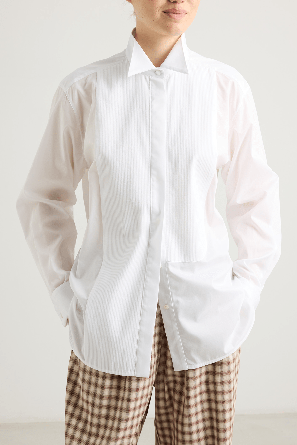 girl in white tuxedo shirt and checked pants
