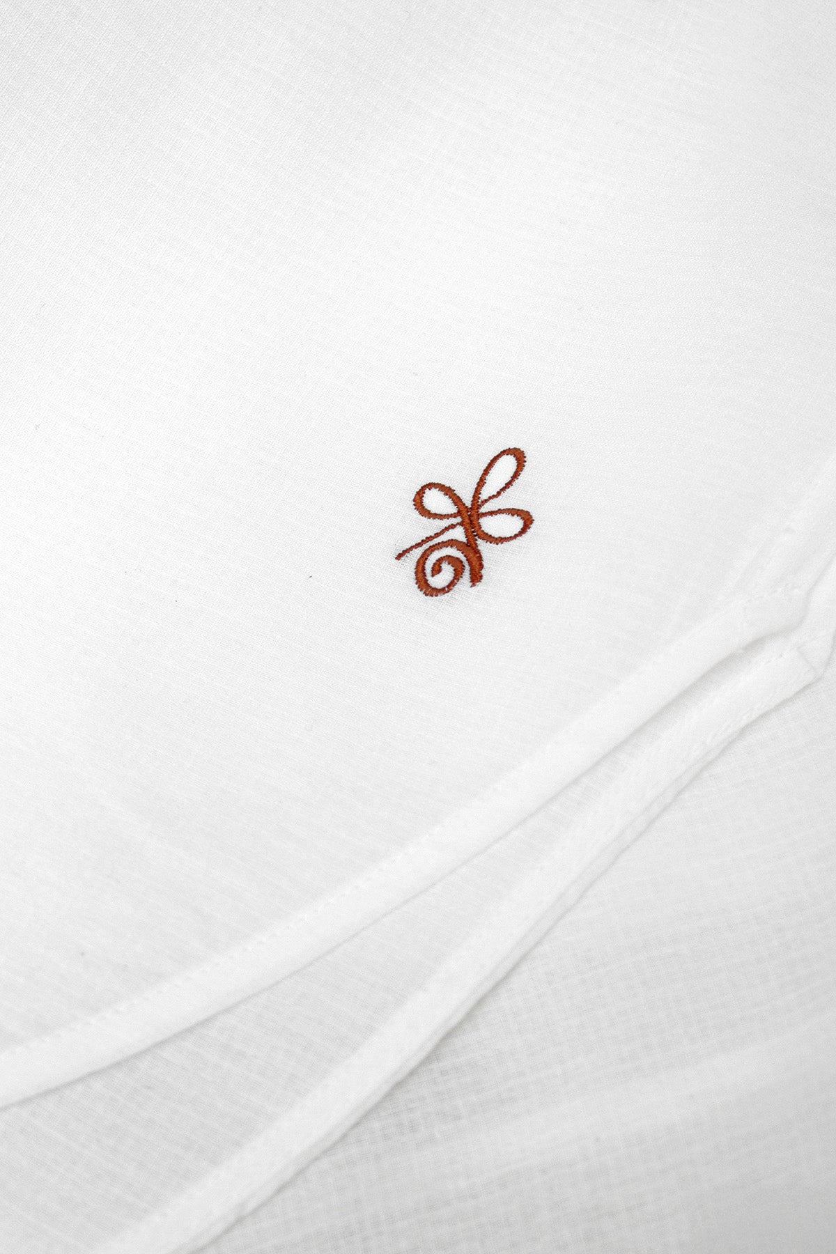 Close-up of the bronze embroidery on Viola cotton-viscose blouse, adding a delicate detail.